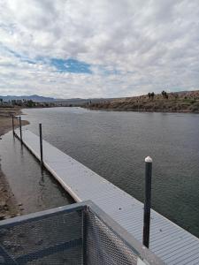 a dock in the middle of a body of water at Beautiful Riverview Condo with Boatlaunch in Bullhead City