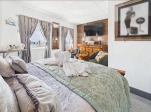 a bedroom with a bed with a towel on it at Kings Boutique Hotel in Blackpool