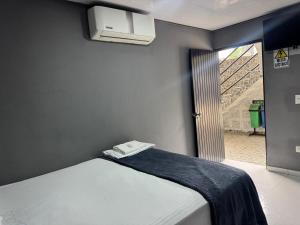 a bedroom with a bed and a window with a staircase at Los Cabos in Bahía Solano