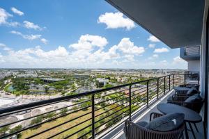 a balcony with chairs and a view of a city at Luxury Condo - 3B3B with Amazing Skyline View in Miami