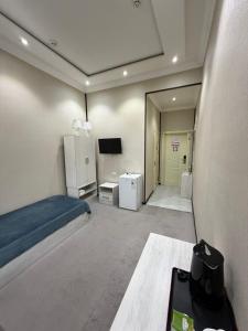 a bedroom with a bed and a tv in it at Shoxdiyor in Angren