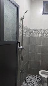 a bathroom with a shower and a toilet at Maison marhaba2 app2 in Inezgane