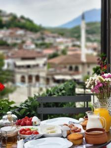 a table with food on it with a view of a city at Sokak Boutique Hotel in Berat
