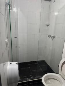 a bathroom with a shower and a toilet at Los Cabos in Bahía Solano