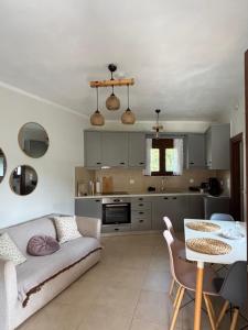 a living room with a couch and a table at The Garden House, Sitia in Sitia