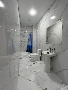 a bathroom with a sink and a toilet and a mirror at Shoxdiyor in Angren +18 photos