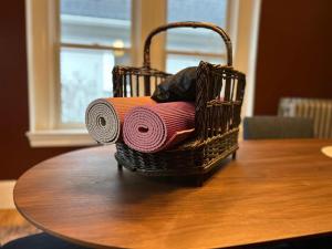 a basket of towels sitting on top of a table at State St Parlor Walk Downtown Newly Designed in Portsmouth