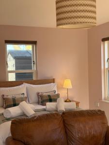 a living room with a bed and a couch at The Rookery in Orkney