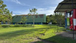 a large building with a green building at Finca Ecoturística Canaguaros in Tauramena
