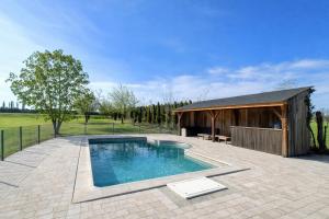 a swimming pool in a patio with a building at Le Rêve de Poulaines - Camping Naturiste 1 JUIN - 30 SEPTEMBRE et chambres d'hôtes TOUTE L'ANNÉE in Poulaines