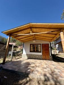 a house with a wooden roof and a patio at Cielo Azul 2 in Villa Pehuenia