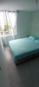 a bedroom with a bed and a window at Ensueño 904 in Armenia