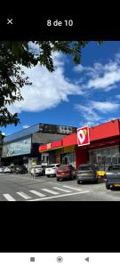 a building with cars parked in front of a street at Ensueño 904 in Armenia +5 photos