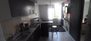a small kitchen with a sink and a counter at Ensueño 904 in Armenia