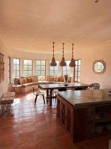 a large living room with tables and a couch at Tierra Alta Boho House in San Miguel de Allende +42 photos