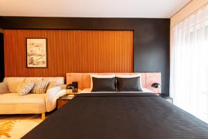a bedroom with a large bed and a couch at Nova Apartments in Prizren