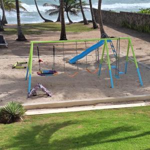 a playground on the beach with a swing at Urbanutopia Apartment A109 in Villas del Mar