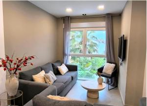 a living room with a couch and a window at POWER HOME in Granada