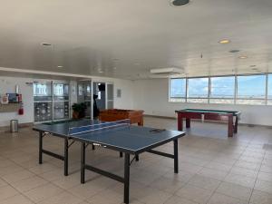 a room with two ping pong tables in it at Flat no Hotel Blue Tree in Manaus