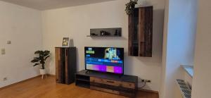 a living room with a flat screen tv on a stand at Ferienwohnung am Töpferberg in Löbau