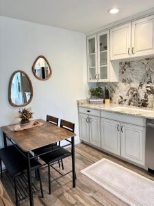 a kitchen with white cabinets and a wooden table at Eagles Roost Haven - Cozy Ski View Condo in Brian Head
