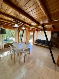 a living room with a table and chairs and a couch at Cielo Azul 4 in Villa Pehuenia