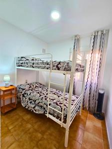 a bedroom with two bunk beds in a room at Bungalow Oaxaca: Playa de La Mata in Torrevieja