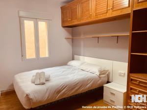 a bedroom with a bed with two towels on it at Carbonería 4 in Soria