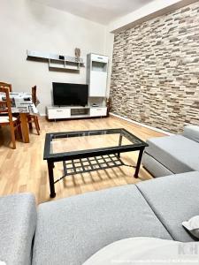 a living room with a couch and a glass coffee table at Carbonería 4 in Soria