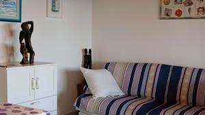 a living room with a couch and a pillow at Casa Paradiso - Panoramic Sea View & Jacuzzi in Terracina