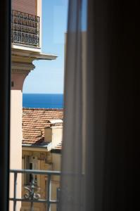 a view of the ocean from a balcony of a building at MONTE CARLO BORDER - exclusive & modern flat in Beausoleil