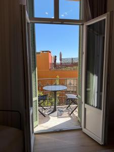 a door open to a patio with a table outside at MONTE CARLO BORDER - exclusive & modern flat in Beausoleil