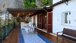 an outdoor patio with a table and a bench at Casa Paradiso - Panoramic Sea View & Jacuzzi in Terracina