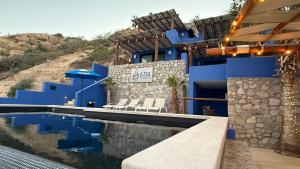 a house with blue walls and a swimming pool at Azul Beach Kite Resort in El Sargento