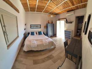 a bedroom with a bed in the middle of a room at Appartamento I TRE SANTI in Bisceglie