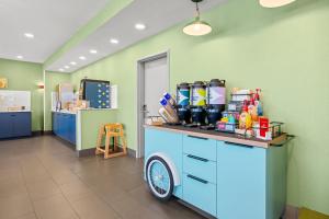 a room with a counter with a cart with drinks on it at Spark by Hilton Pelham Birmingham I 65 in Pelham