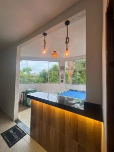 a bathroom with a tub and a swimming pool at Casa design Piri no centro de Pirenópolis in Pirenópolis