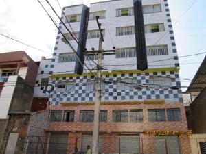 a tall building with checkered tiles on it at Pousada Popular in Três Marias