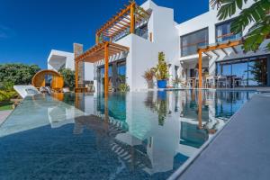 a swimming pool in front of a house at Ericeira Ocean View Villa in Ericeira