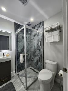 a bathroom with a shower with a toilet and a sink at Luxury Nest B&B in Niagara-on-the-Lake +13 photos