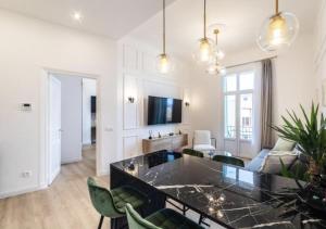 a living room with a couch and a table at MONTE CARLO BORDER - exclusive & modern flat in Beausoleil