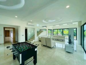 a large living room with a foosball table at villa rach in Assinie