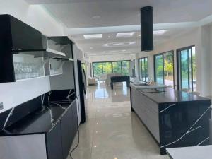 a kitchen with a black and white counter top at villa rach in Assinie +14 photos