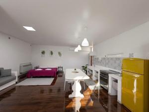 a living room with a white table and a kitchen at Al Fluviale in Ferrara