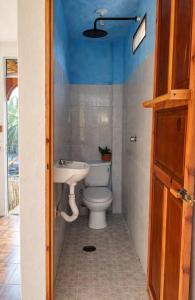 a bathroom with a toilet and a sink at Oceanfront, AC and Parking, La Punta in Paso Hondo +59 photos