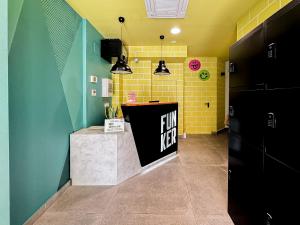 a fun tax counter in a room with yellow and green walls at Funker Hostel in Málaga