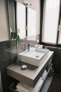 a bathroom with a white sink and a mirror at casa Monia in Roe +49 photos