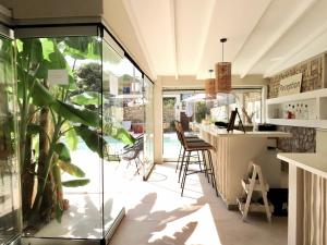a room with a bar and a plant at Aroma Villa & Studios in Limenas