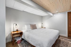 a bedroom with a bed and a wooden ceiling at Mt Rushmore Duplex in Rapid City