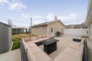a patio with a couch and a grill in a yard at Mt Rushmore Duplex in Rapid City